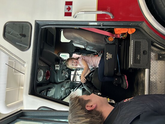 Kindergarten child sitting in a fire truck